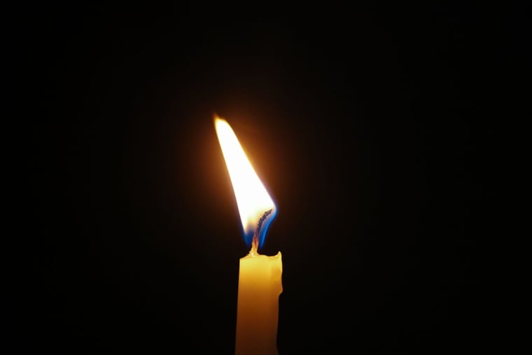 Burning memorial candle representing cremation services in Mooreland, IN.